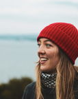 Women wearing a red Merino Wool Beanie hat and black and white Merino Wool neck warmer