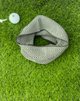Patterned scarf golf ball marker on green grass