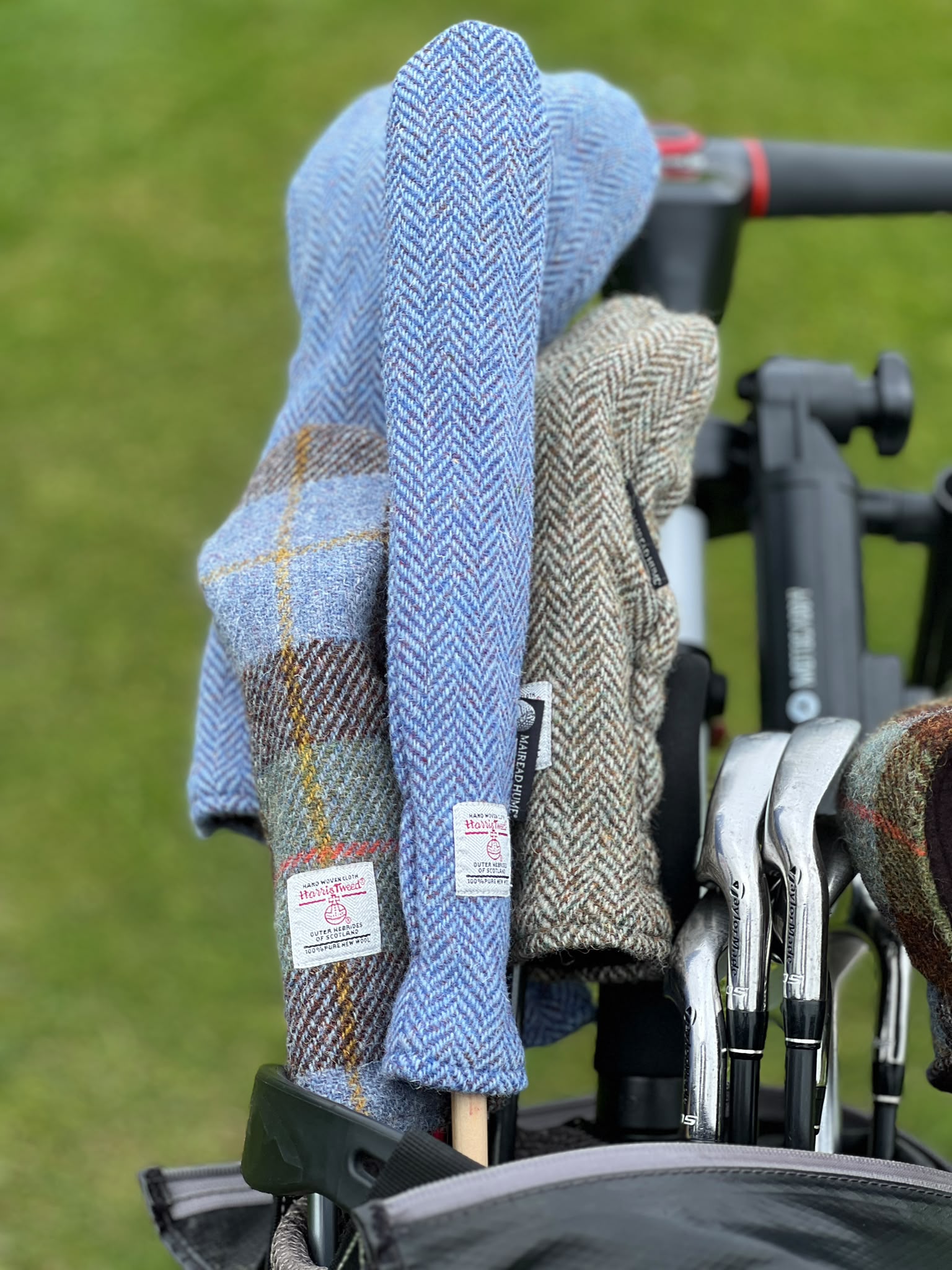 Mairead Hume® Harris Tweed® Golf Alignment Stick Cover in a golf bag on the golf course — lifestyle shot showing the cover in real-world use